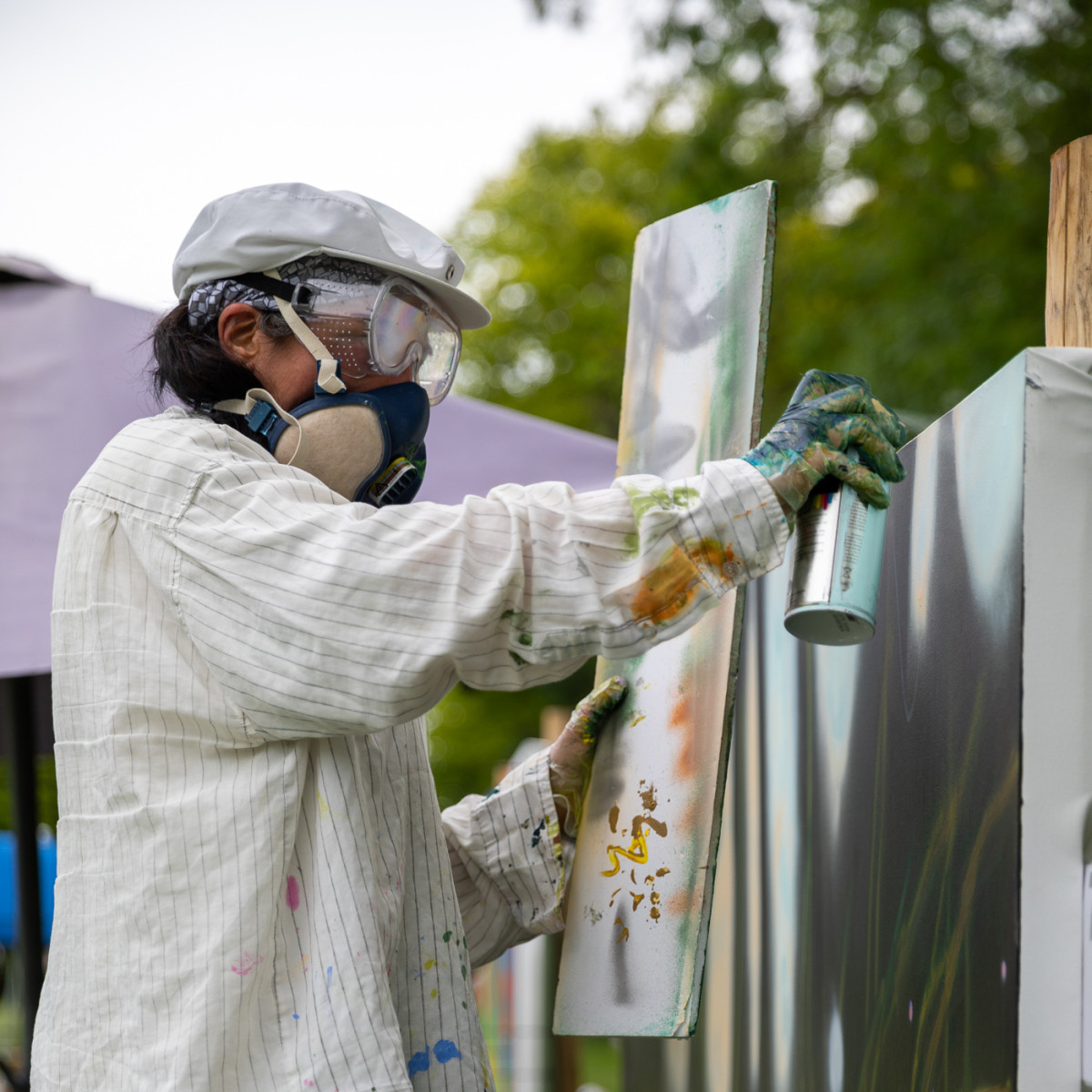During a performance of large scales painting, using spray paint